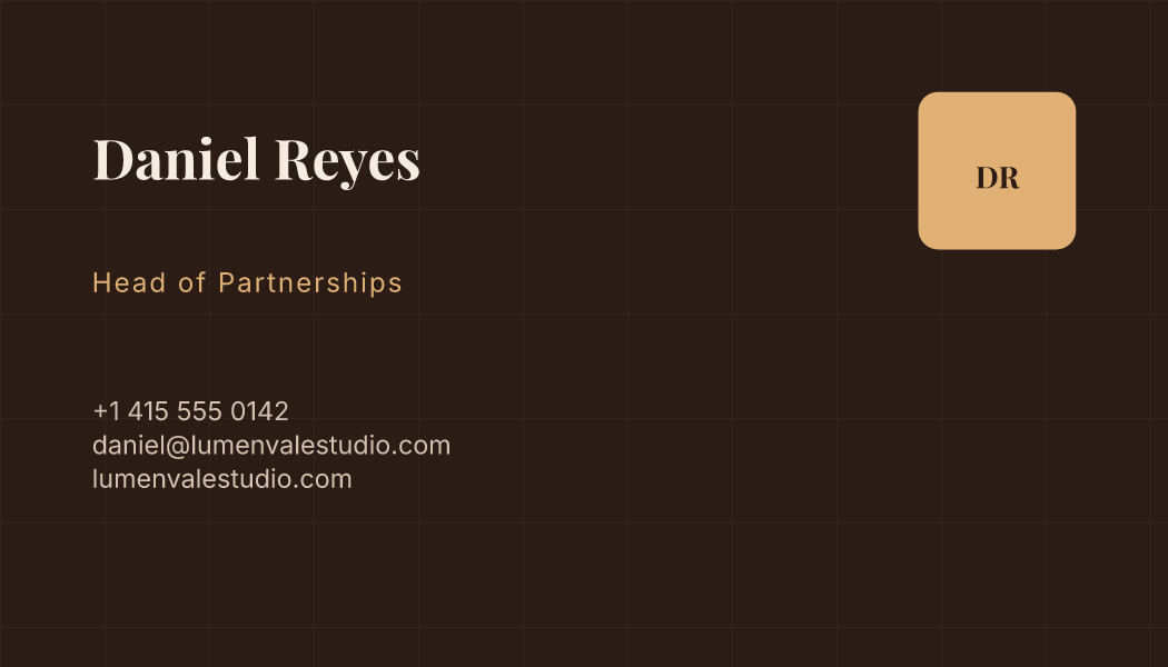 A deep brown business card with Daniel Reyes's name, his job in gold and a square seal carrying his initials.