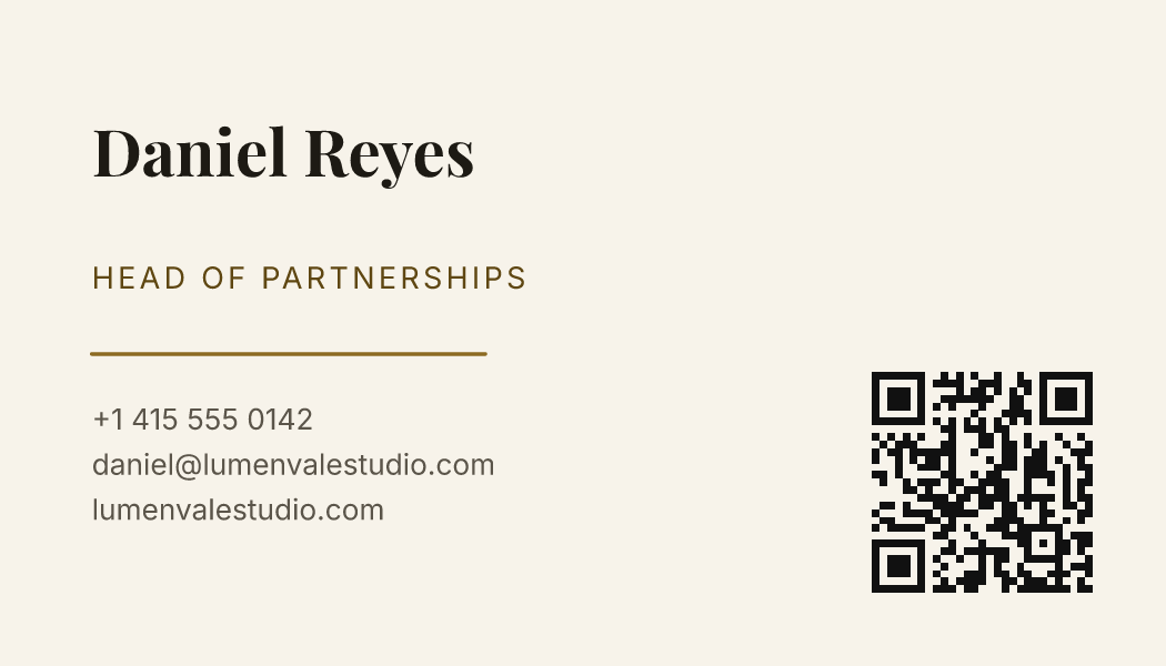 A cream business card with Daniel Reyes's name in a serif face, a gold rule, his contact lines and a QR code on the right.